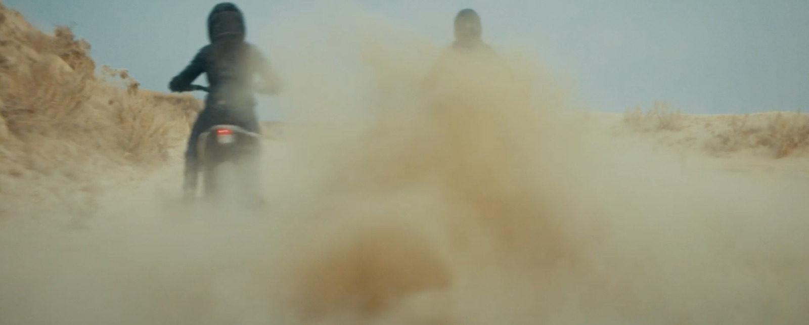 a couple of people riding on the back of a motorcycle