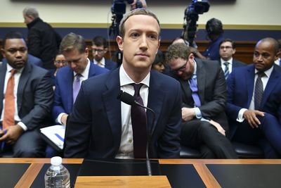 a man in a suit and tie sitting at a table