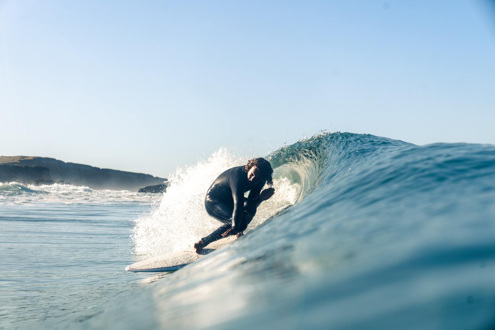 a man riding a wave on top of a surfboard