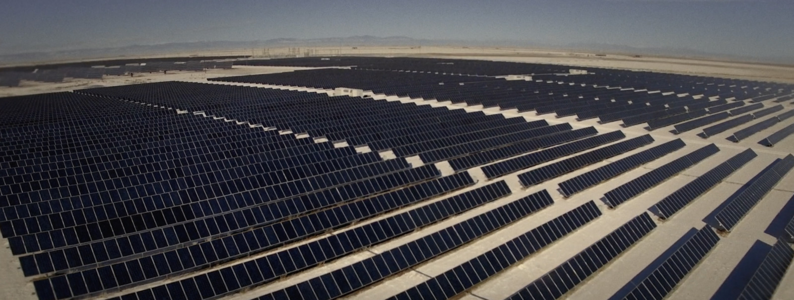 a large array of solar panels in a desert