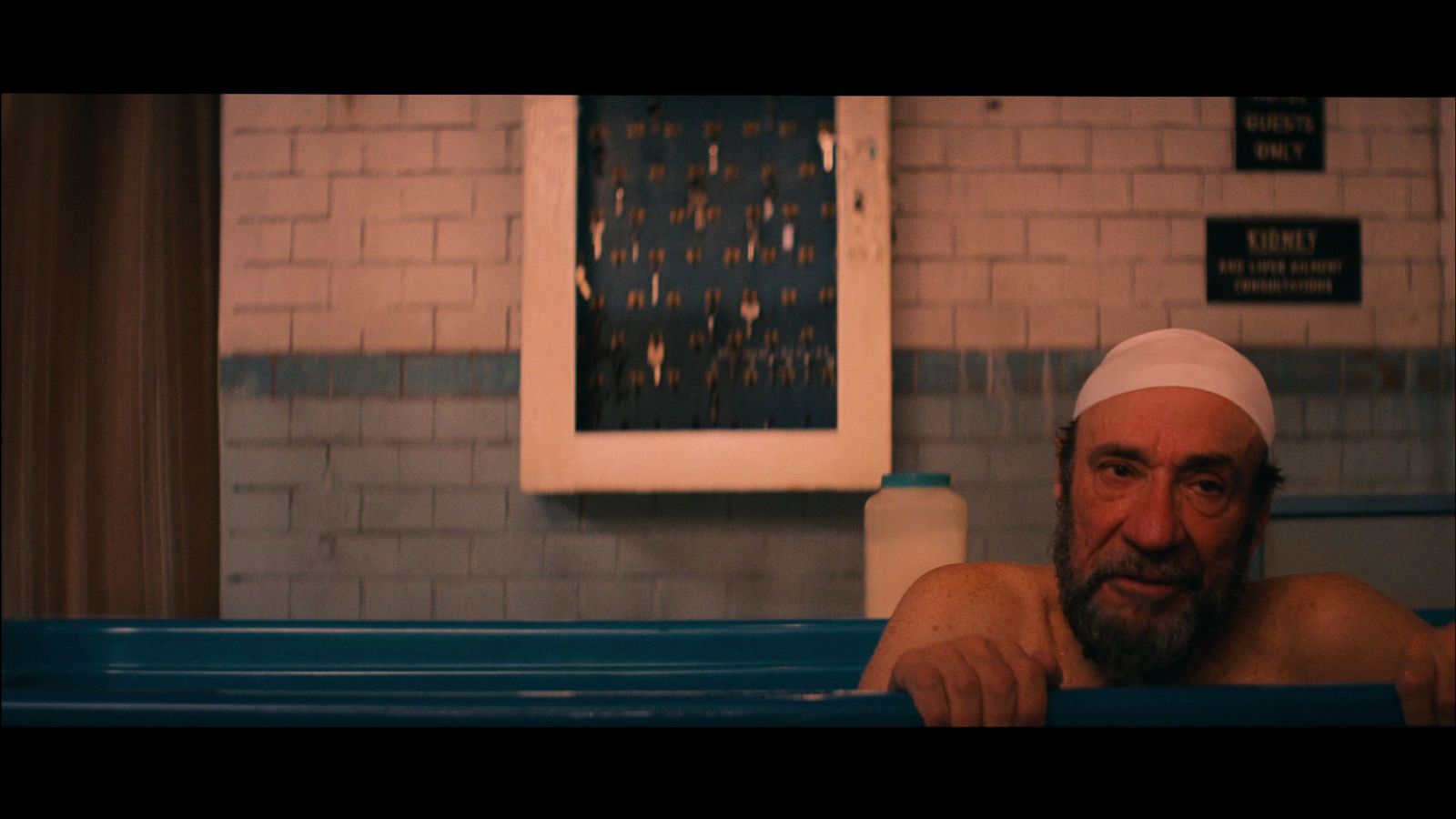 a man in a bathtub with a bandage on his head