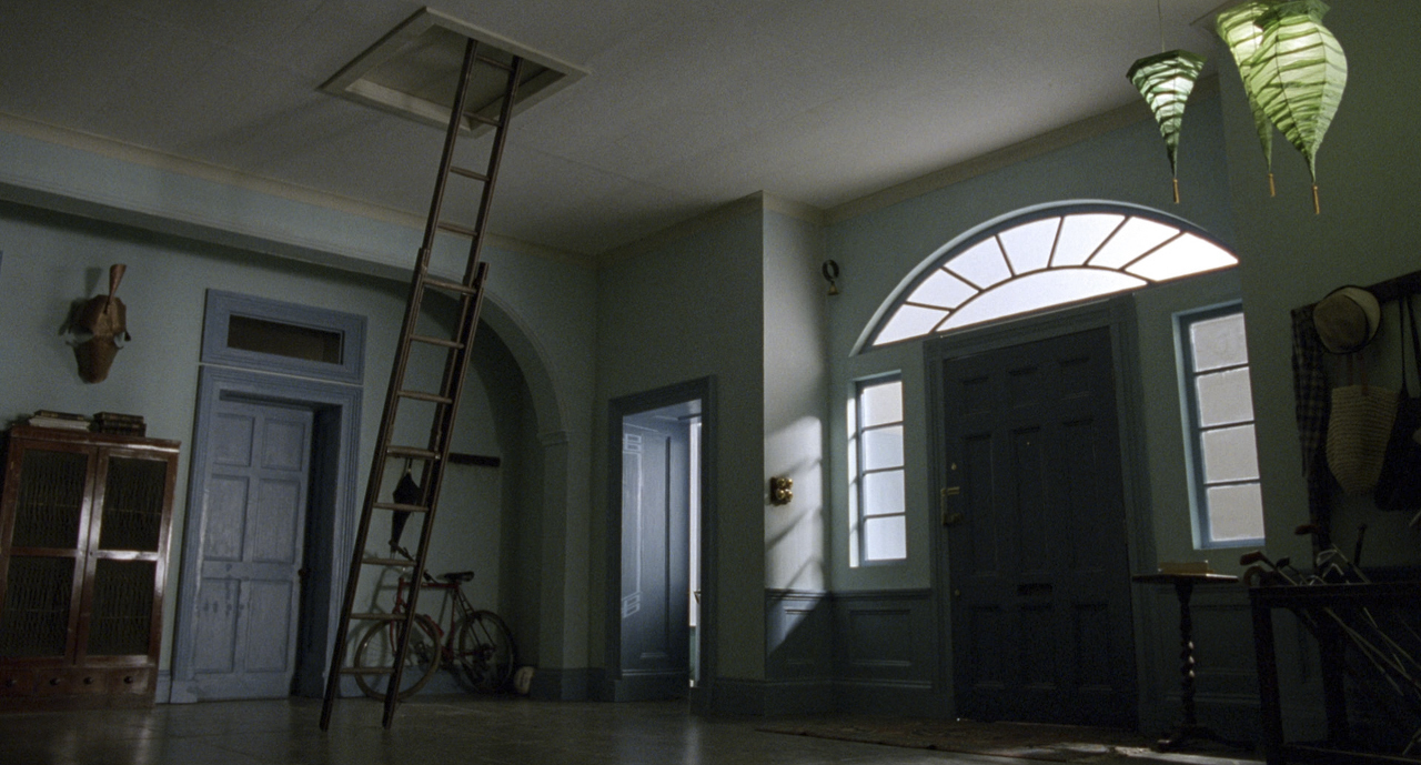 a room with a ladder and a bicycle in it