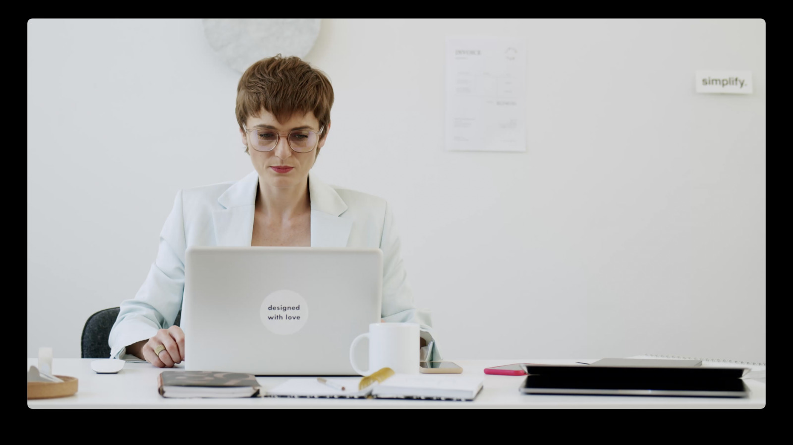 a woman sitting in front of a laptop computer