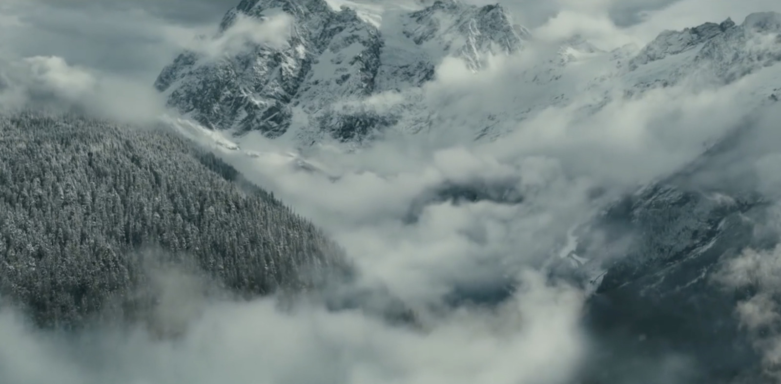 an aerial view of a snowy mountain range