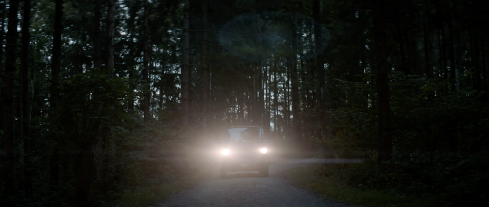 a truck driving down a road at night