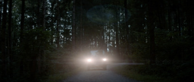 a truck driving down a road at night