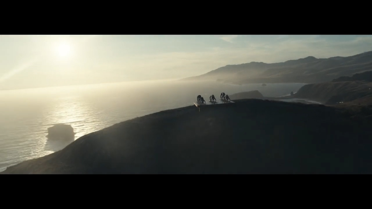 a group of people standing on top of a hill