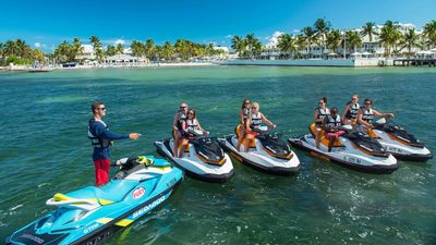 a group of people riding jet skis on top of a body of water