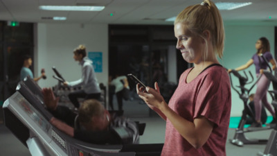 a woman on a cell phone in a gym