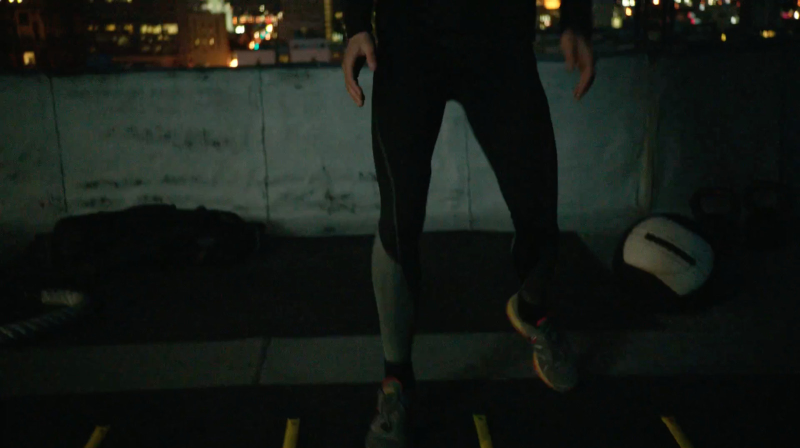 a man standing on a skateboard in the dark