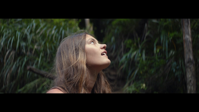 a woman with long hair looking up into the sky