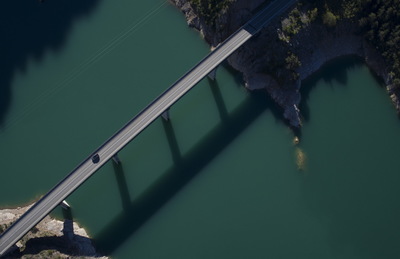 an aerial view of a bridge over a body of water