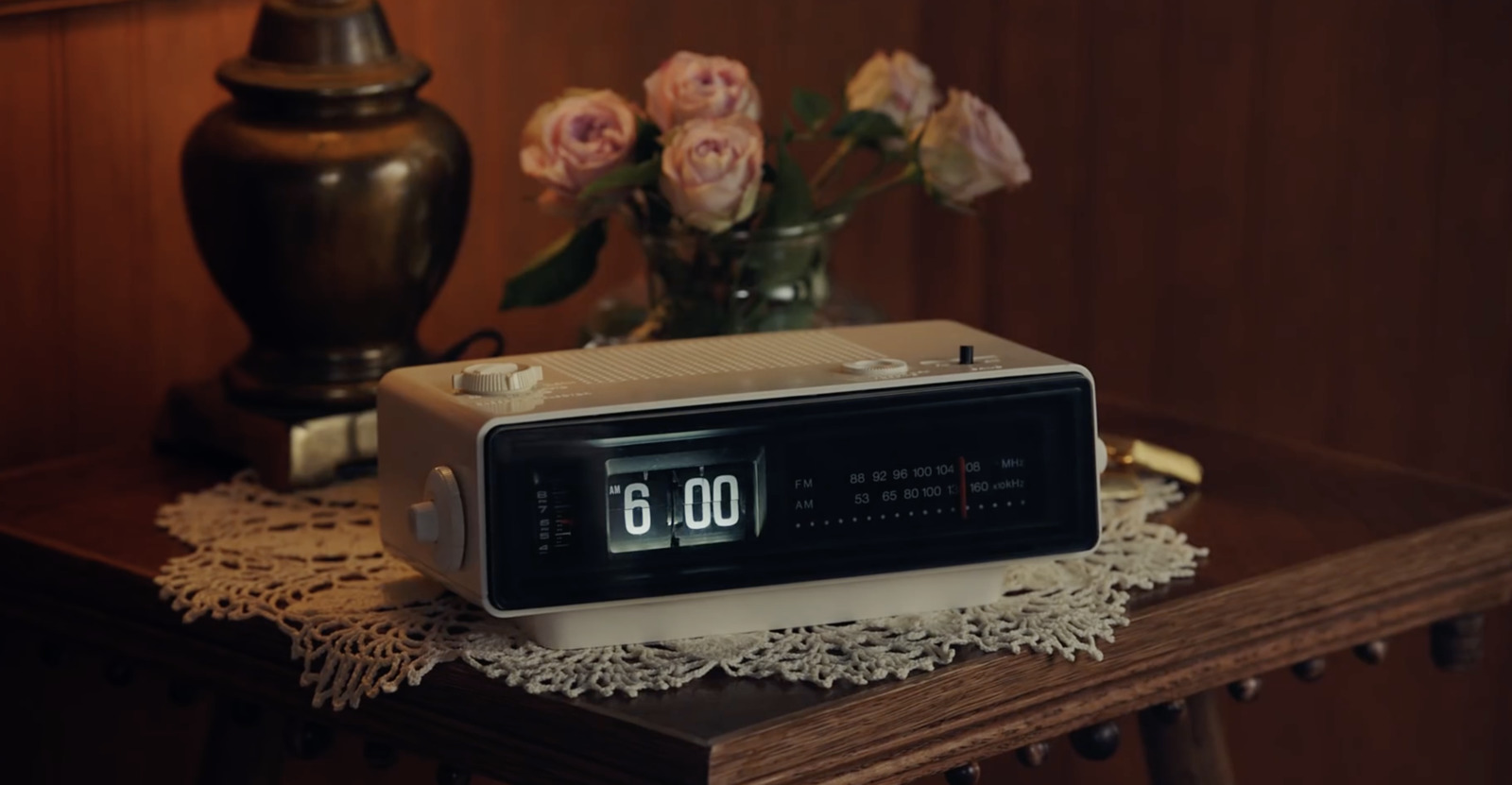 an alarm clock sitting on top of a wooden table