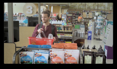 a man standing in a grocery store holding a bag