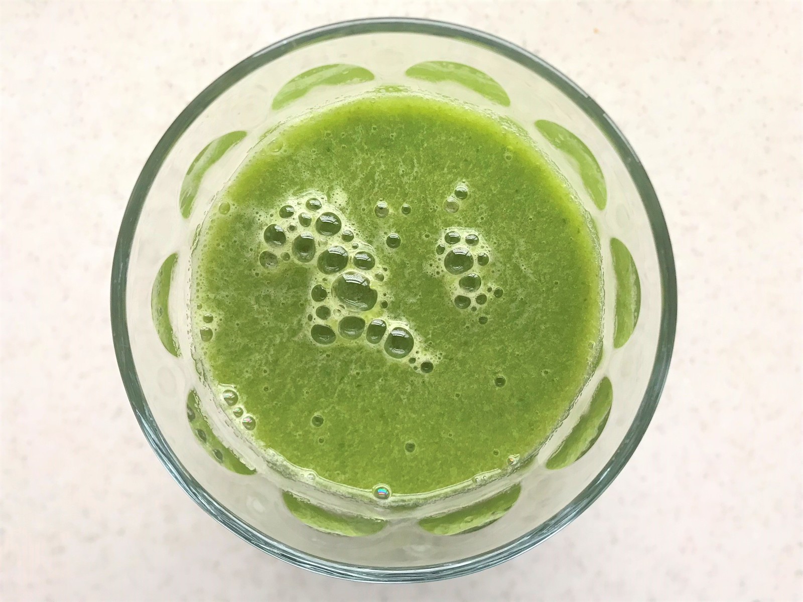 a close up of a green liquid in a glass