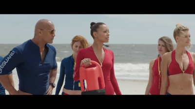 a group of people standing on top of a beach