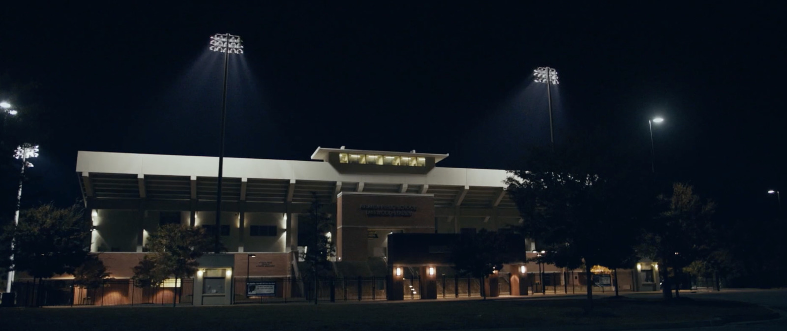 a baseball stadium at night with lights on