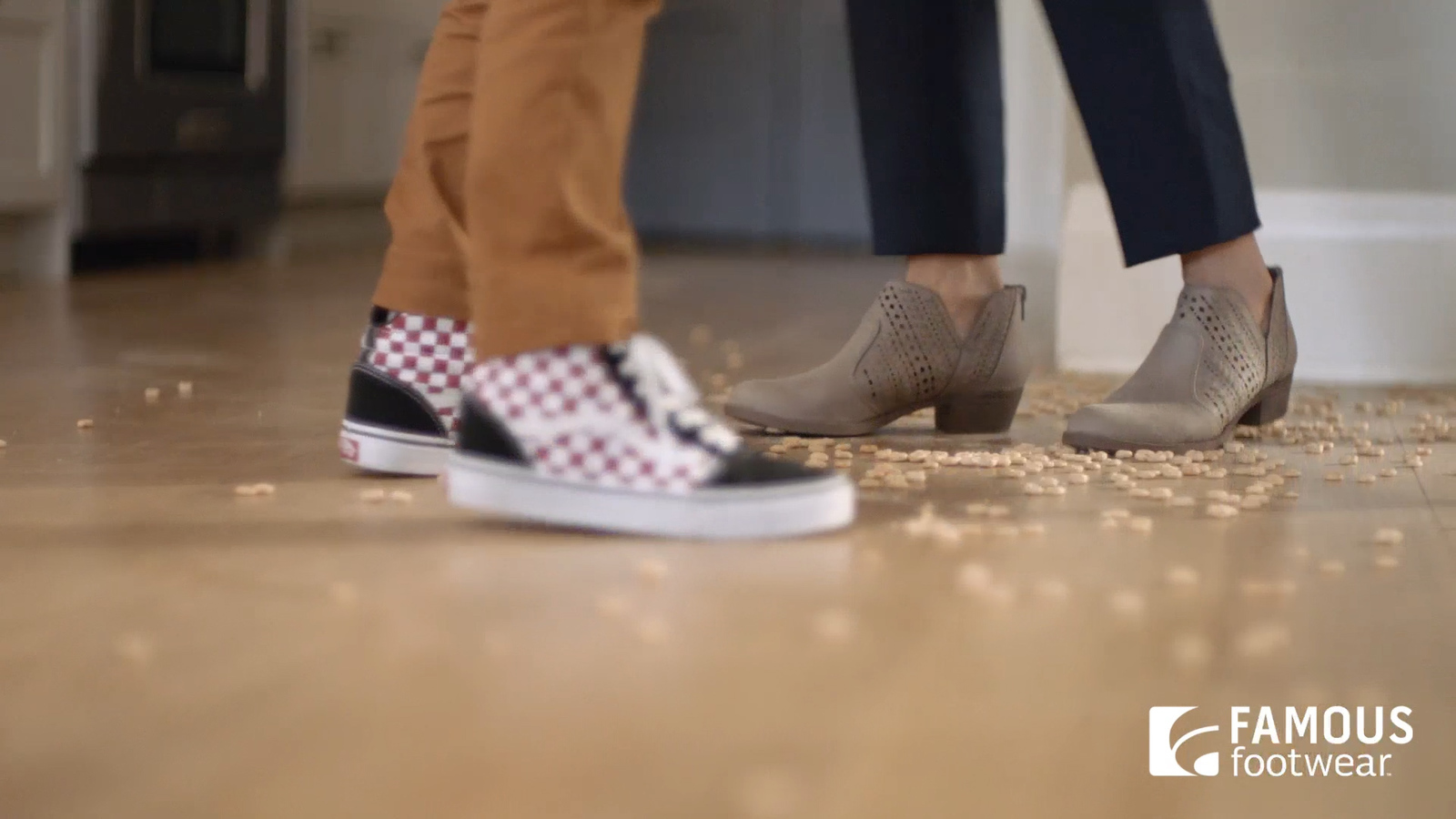 a couple of people standing on top of a wooden floor