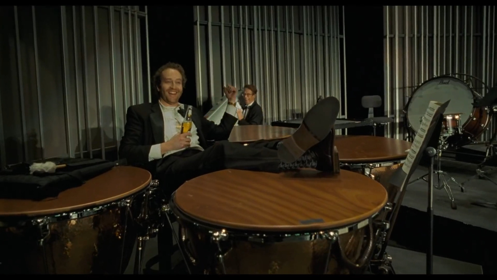 a man sitting in front of a drum set