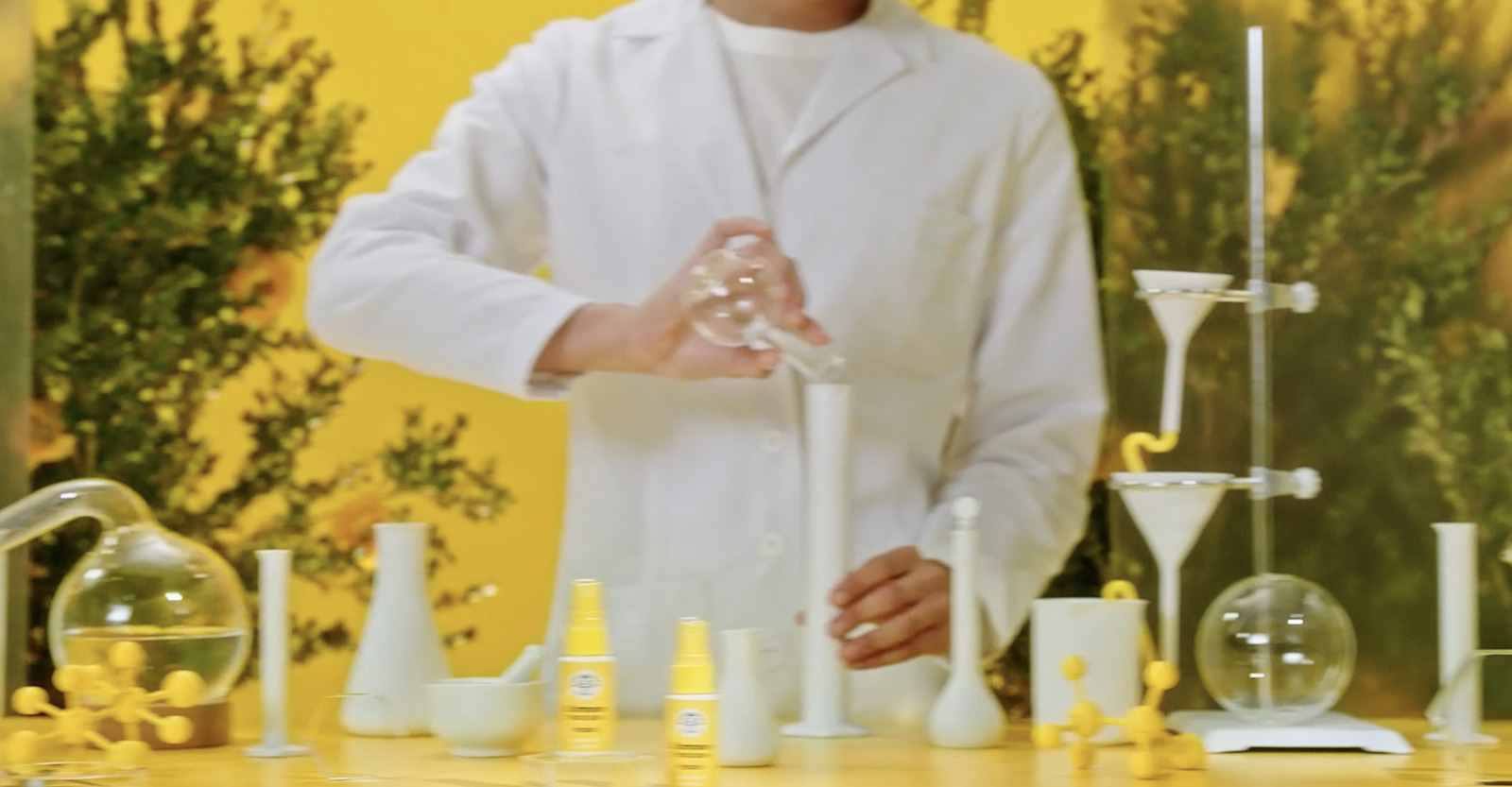 a man standing in front of a table filled with bottles