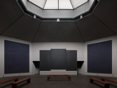 an empty room with benches and a skylight