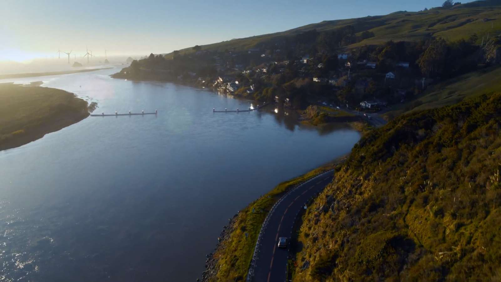 an aerial view of a river and a road