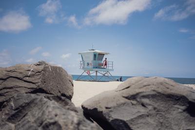 a lifeguard tower on a beach with rocks