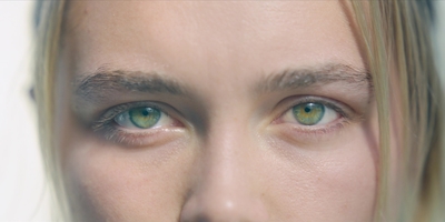 a close up of a person with green eyes