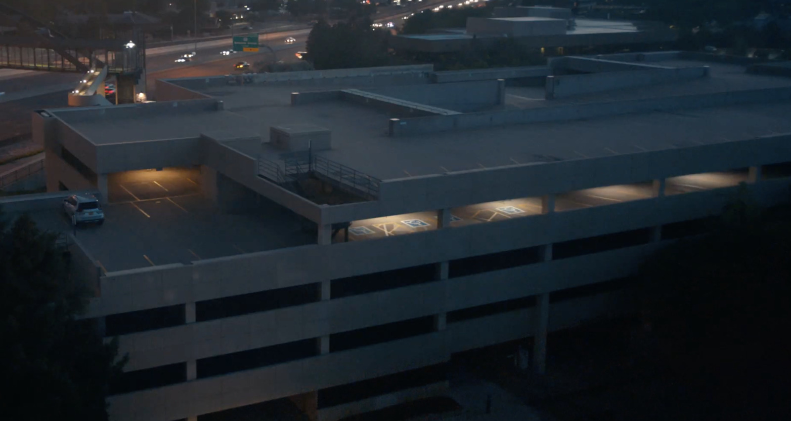 an aerial view of a parking garage at night