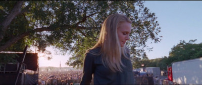 a woman standing in front of a crowd of people