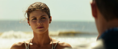 a woman is talking to a man on the beach