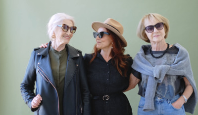 a group of three women standing next to each other