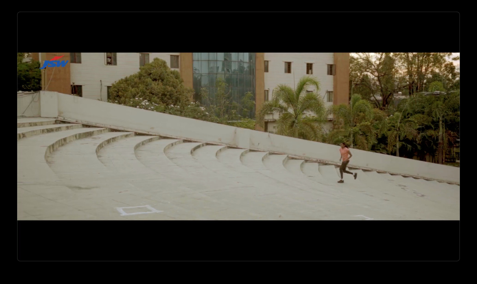 a skateboarder is going down a ramp in a skate park