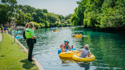 a group of people riding in rafts down a river