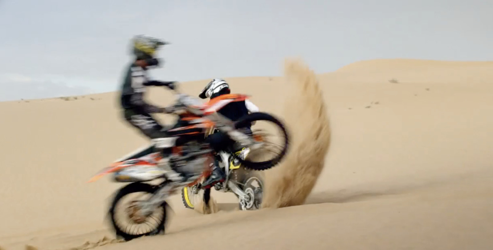 a person riding a dirt bike in the desert