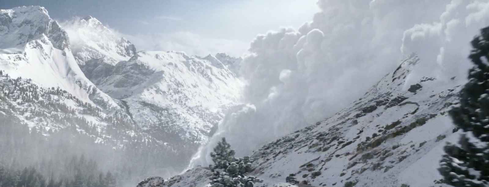 a mountain covered in snow with a sky background