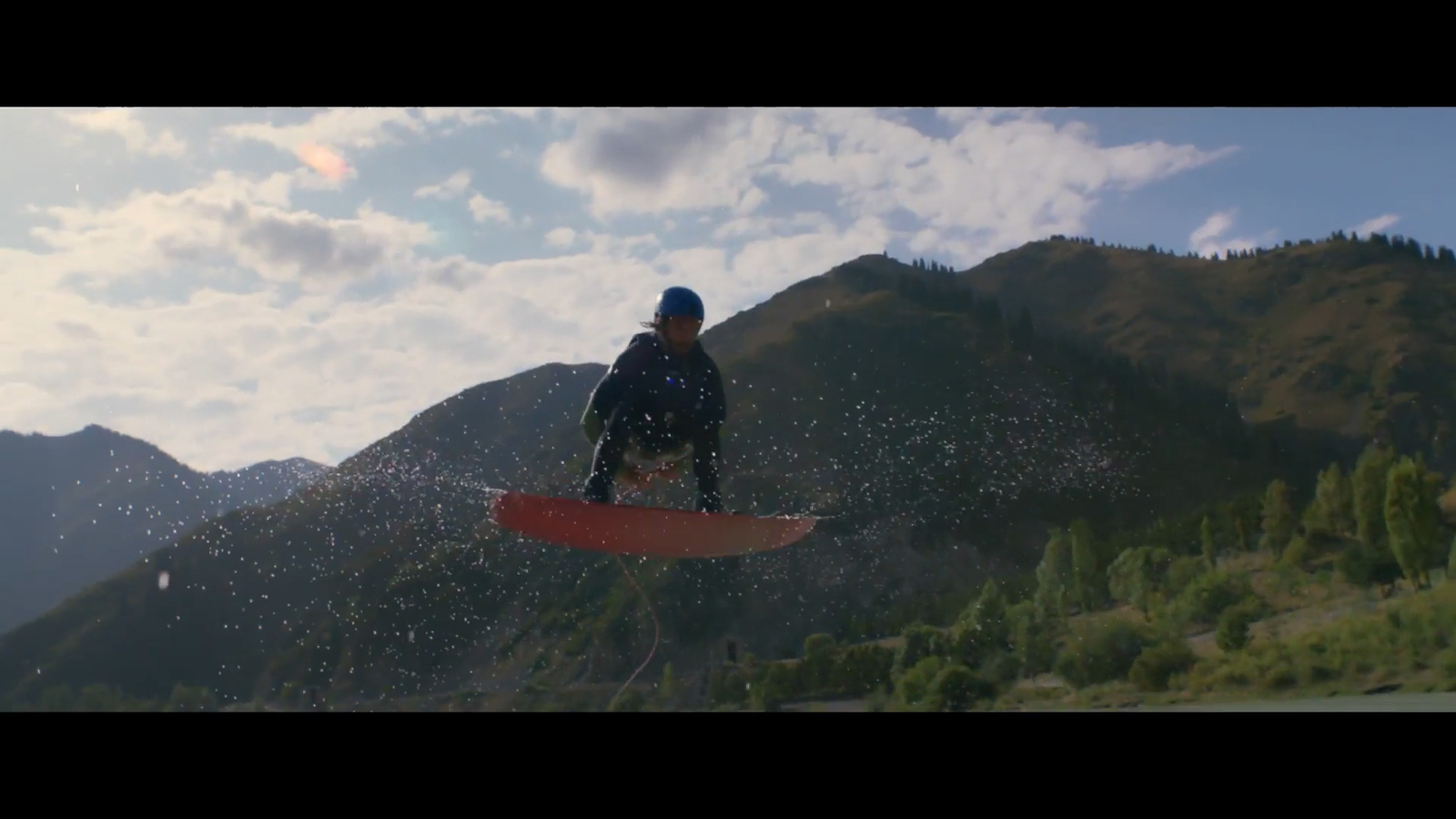 a man riding a snowboard on top of a mountain