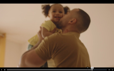 a man holding a little girl in his arms