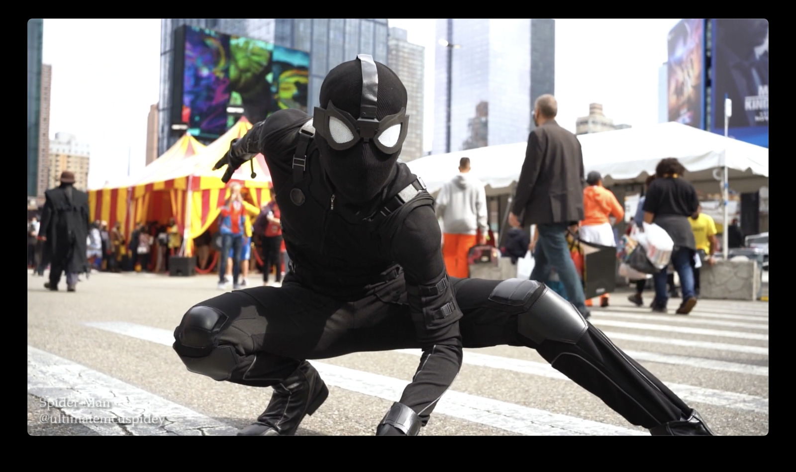 a man dressed in a black suit and mask