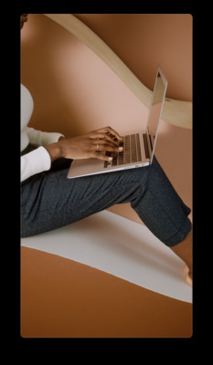 a person sitting on a chair with a laptop