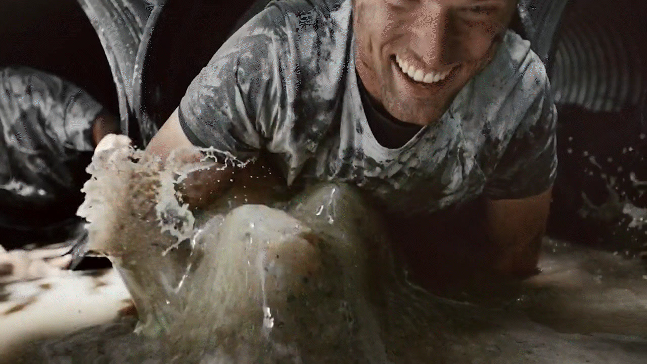 a man laying on the ground covered in water