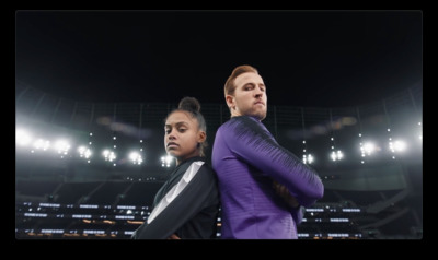 a couple of people that are standing in front of a stadium