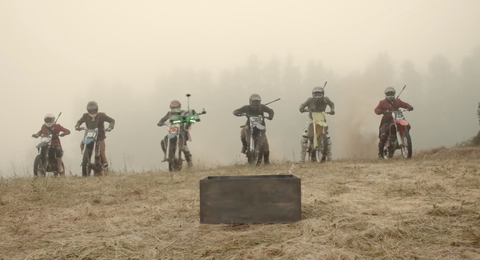 a group of people riding dirt bikes on a hill