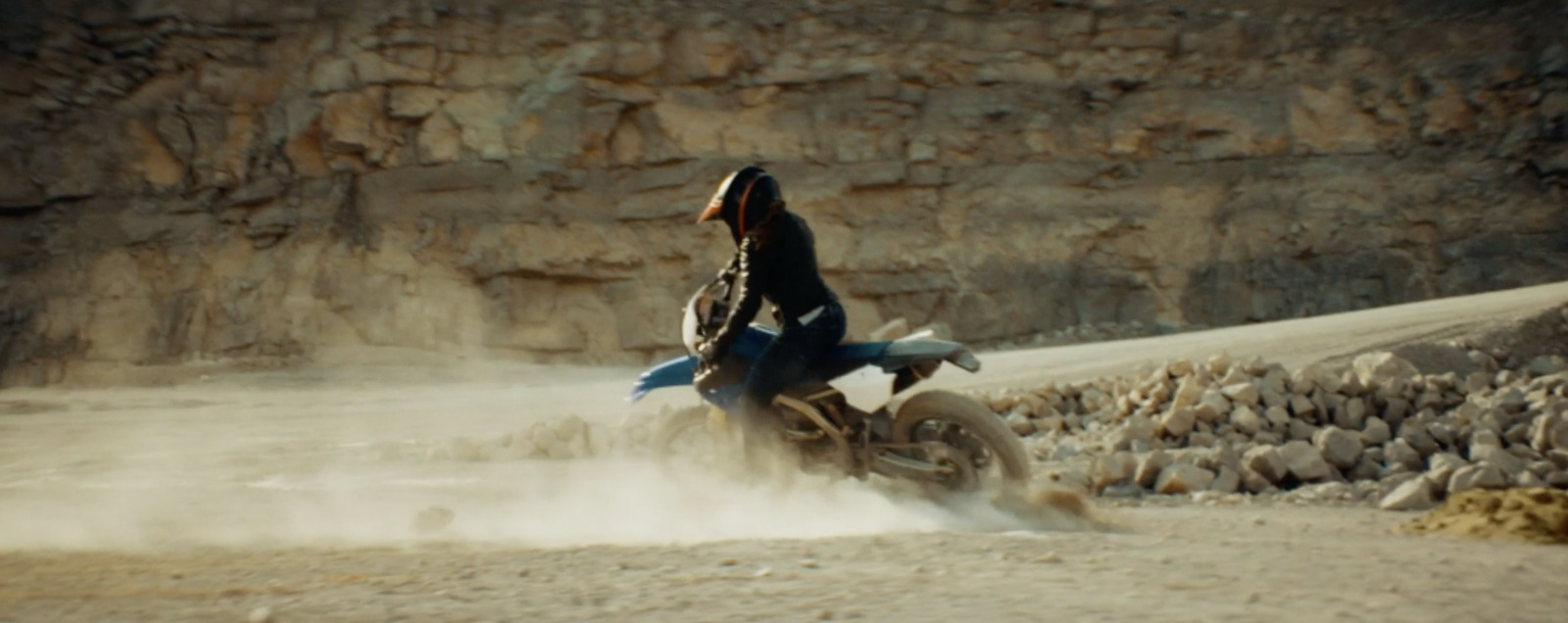 a person riding a dirt bike in the desert