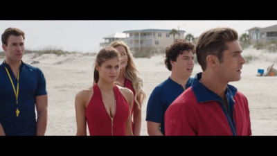 a group of people standing next to each other on a beach