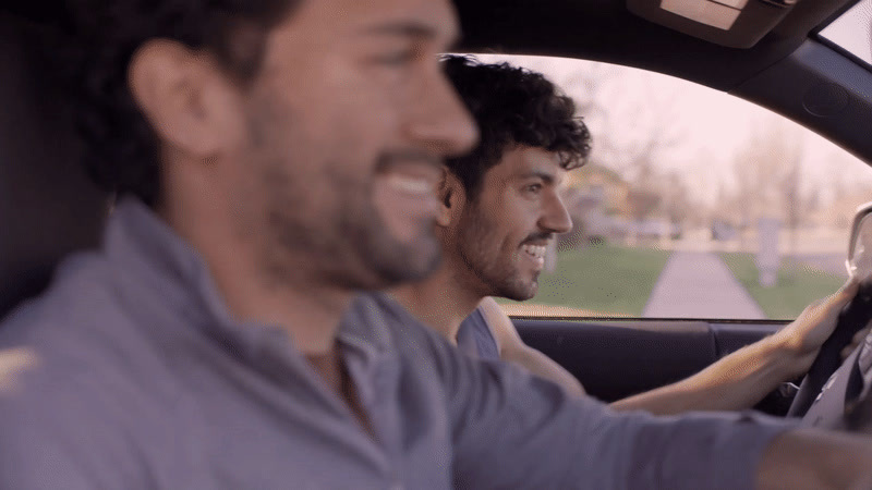 a couple of men sitting in a car