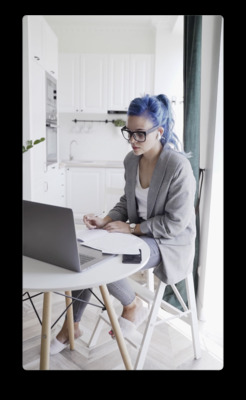 a woman sitting at a table with a laptop