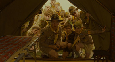 a group of men sitting inside of a tent