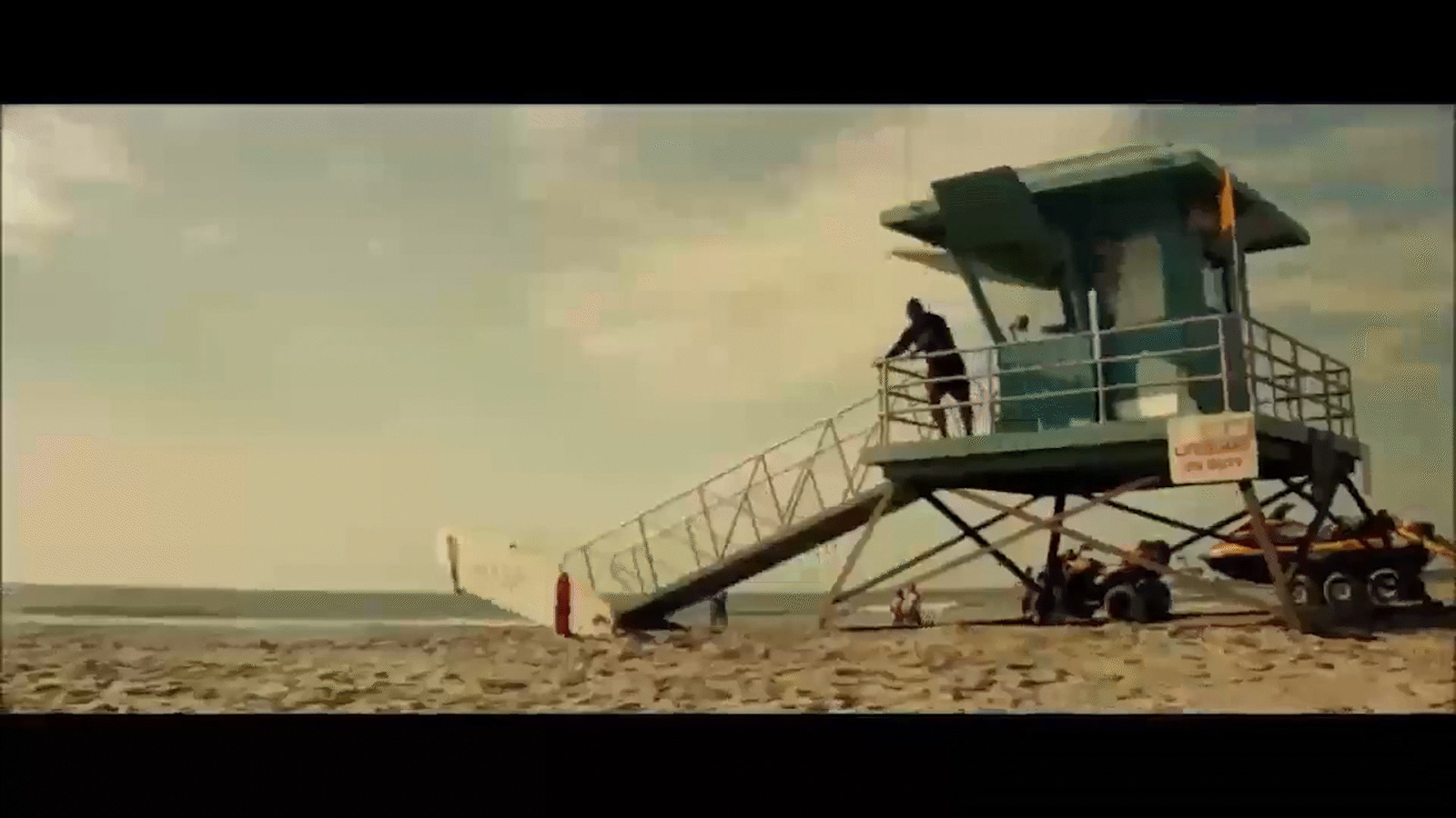 a lifeguard tower sitting on top of a sandy beach