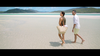 a man and a woman walking on a beach